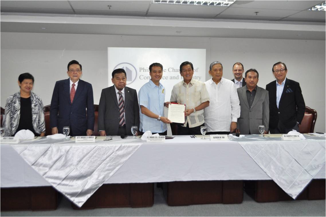 TESDA Director General Joel Villanueva and PCCI President Ambassador Alfredo Yao exchange copy of the Memorandum of Understanding for a public – private partnership in tech-voc training. 